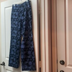 Floral print of light blue and purple on navy.